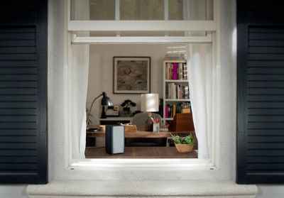 A 5G Gateway device sitting on a table by the window.