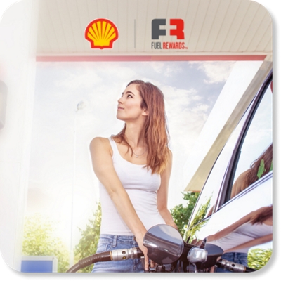 A woman pumps fuel at a Shell station.