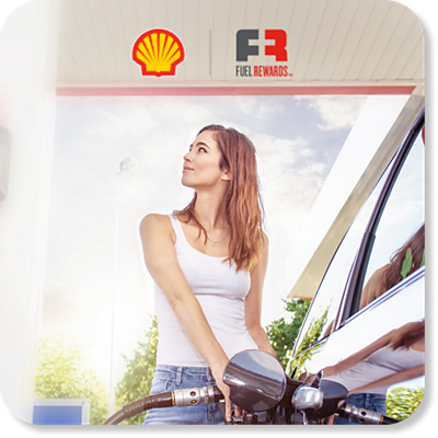 A woman pumps fuel at a Shell station.