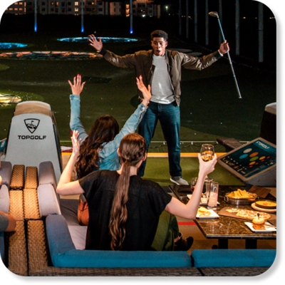 Group of people having fun at Topgolf.
