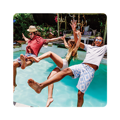 Family jumping into a pool together.