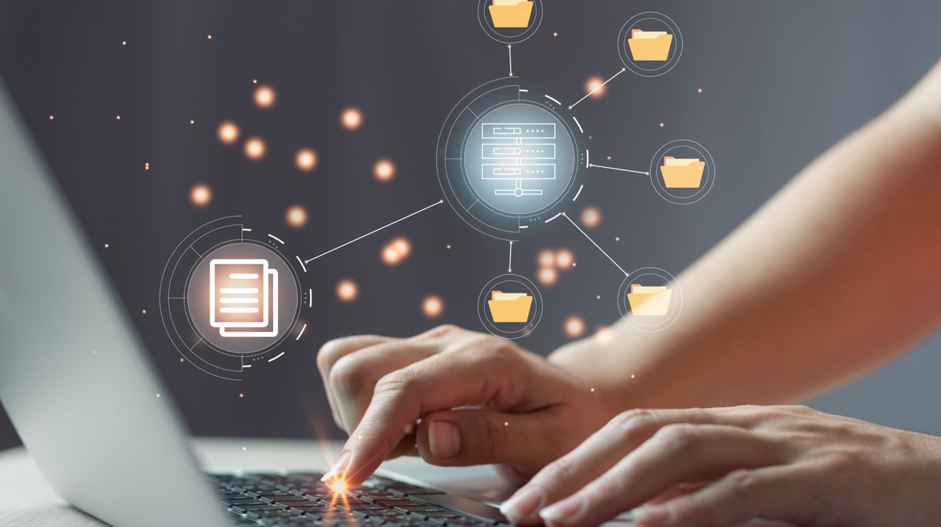Hands on a laptop keyboard with floating network icons showing connected devices and data nodes.