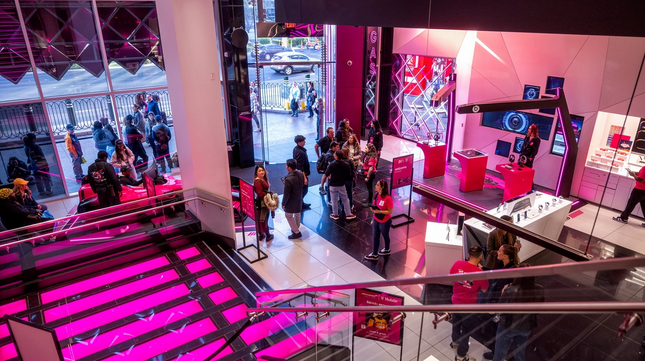 People walking around inside the T-Mobile Las Vegas Signature Store.