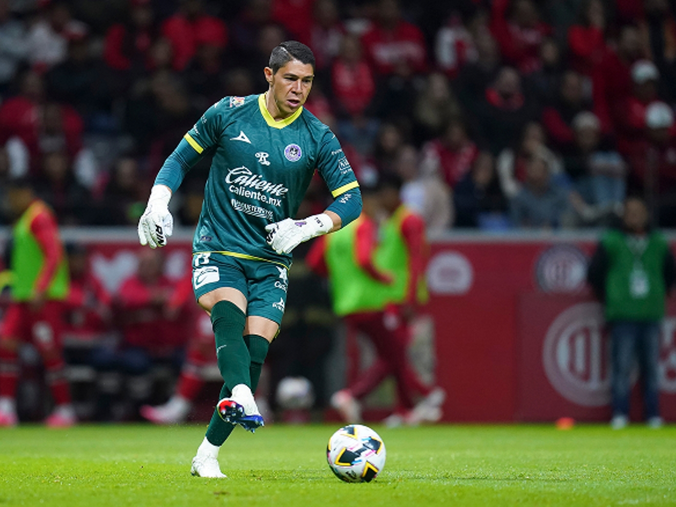 A player kicks a soccer ball.