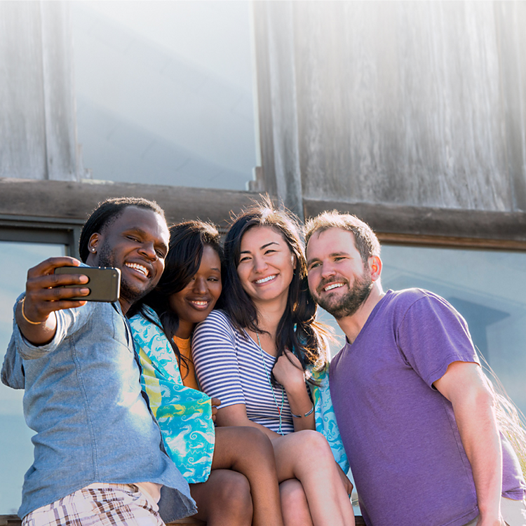 Group of 4 people posing for a selfie