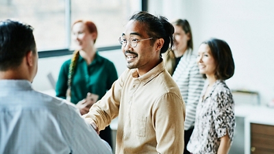 Person in front of an easel with a chart on it making a presentation