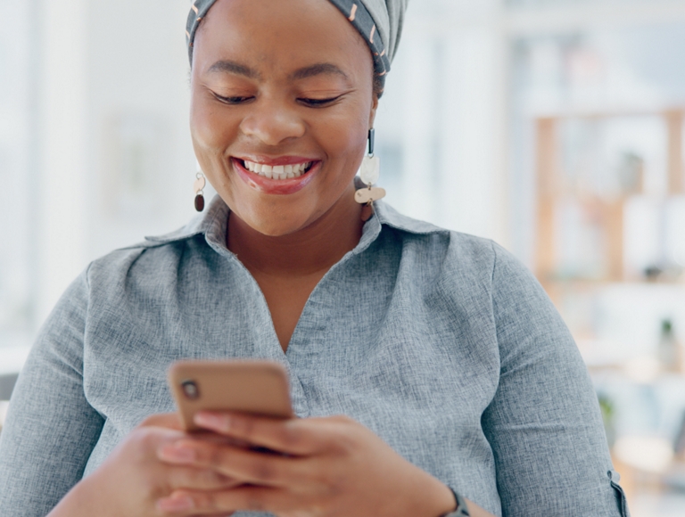 Smiling person using smartphone