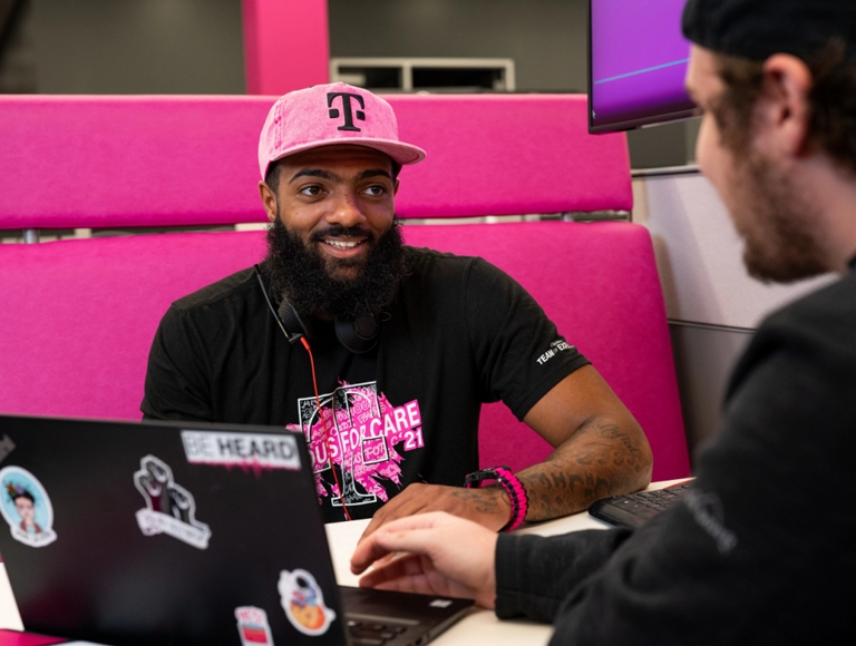 Two T-Mobile employees working together