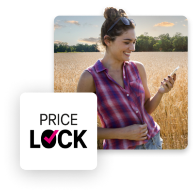 Price Lock. Lady in a wheat field looking at her phone, laughing.