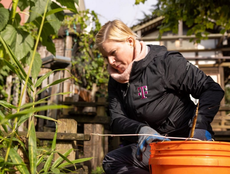 T-Mobile employee working to help clean up a yard