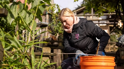 Person in T-Mobile jacket doing gardening work