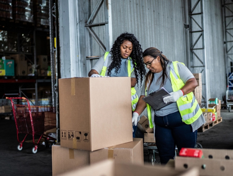 Two T-Mobile employees preparing a box for shipment