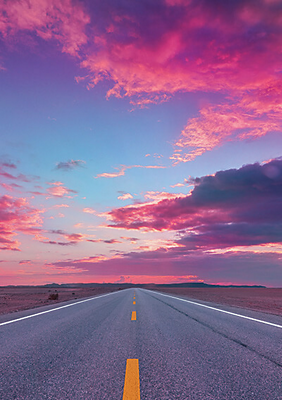 Open road with magenta tinted sky