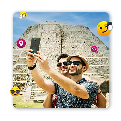 Couple taking a selfie with a Mayan pyramid in the background, surrounded by emojis.