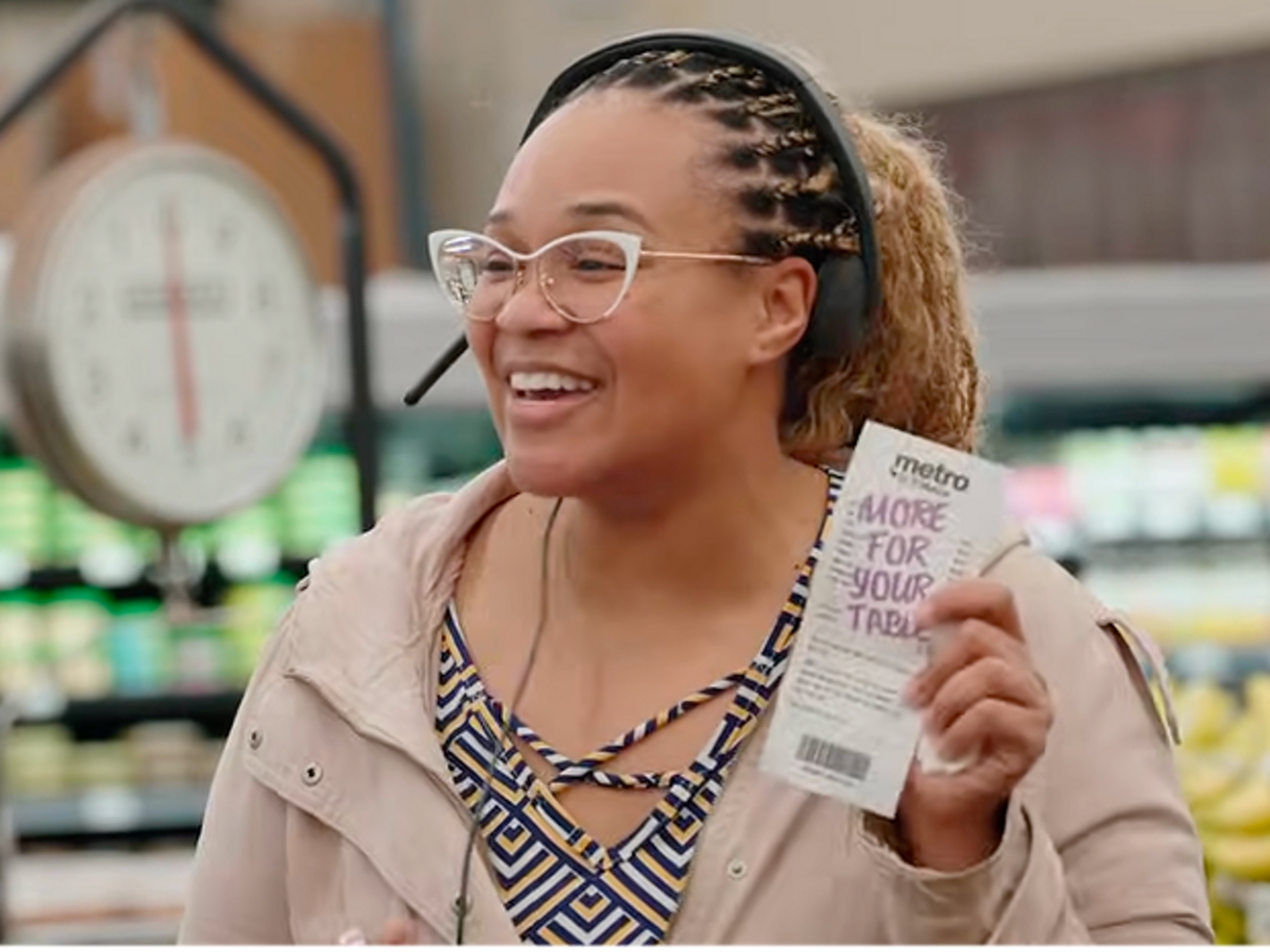 A woman smiles with her receipt.