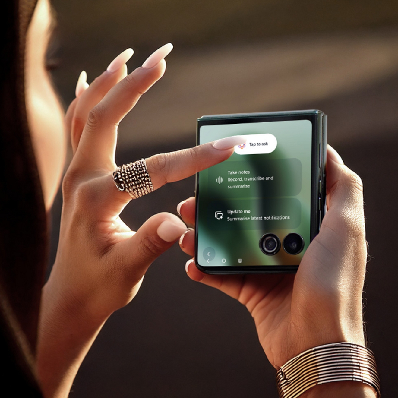 Woman tapping external monitor of her folded motorola razr ultra to ask for assistance from moto ai.
