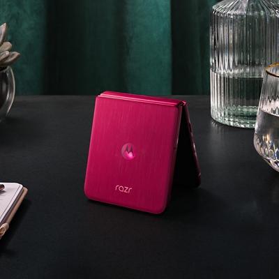 Motorola razr ultra partially folded, standing on nightstand.