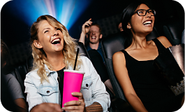 People laughing in a movie theater. 