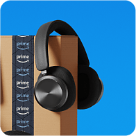 Headphones on top of an Amazon box.