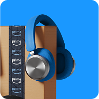 Headphones on top of an Amazon box.