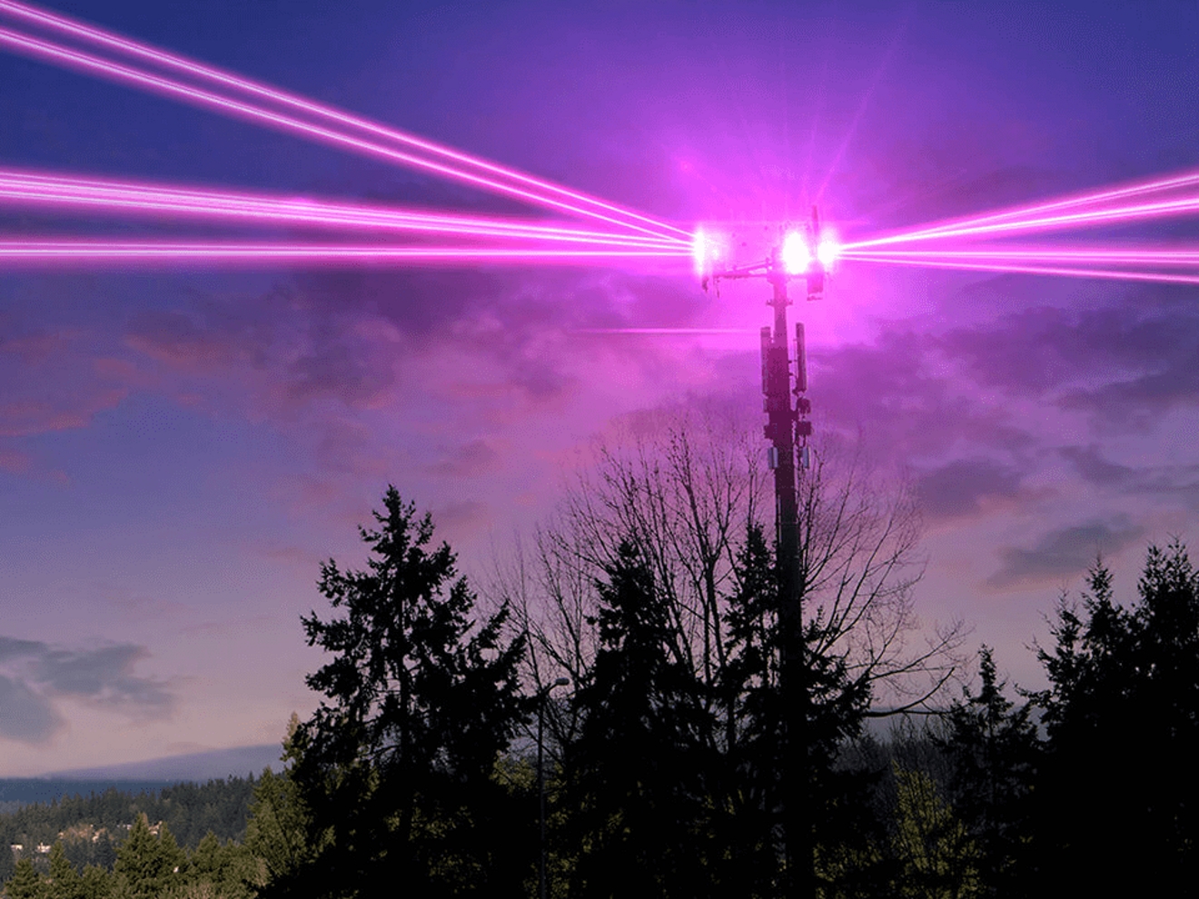 Pink beams glowing from a cellular tower.