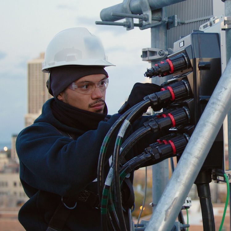 Professional tower climber performing maintenance on a cell tower.