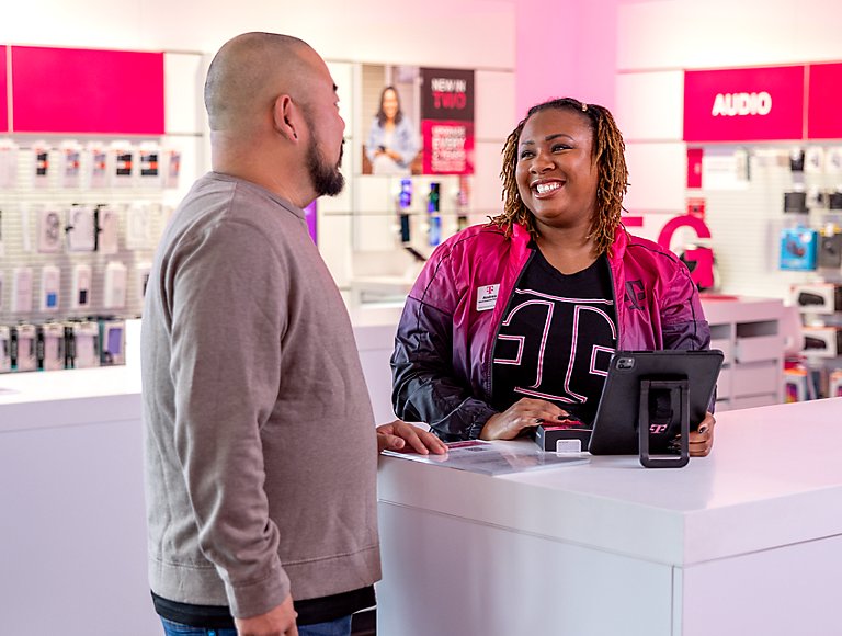 T-Mobile retail employee helping a customer make a purchase.