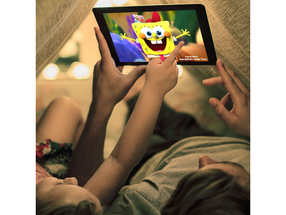 Man and child watching spongebob on tablet