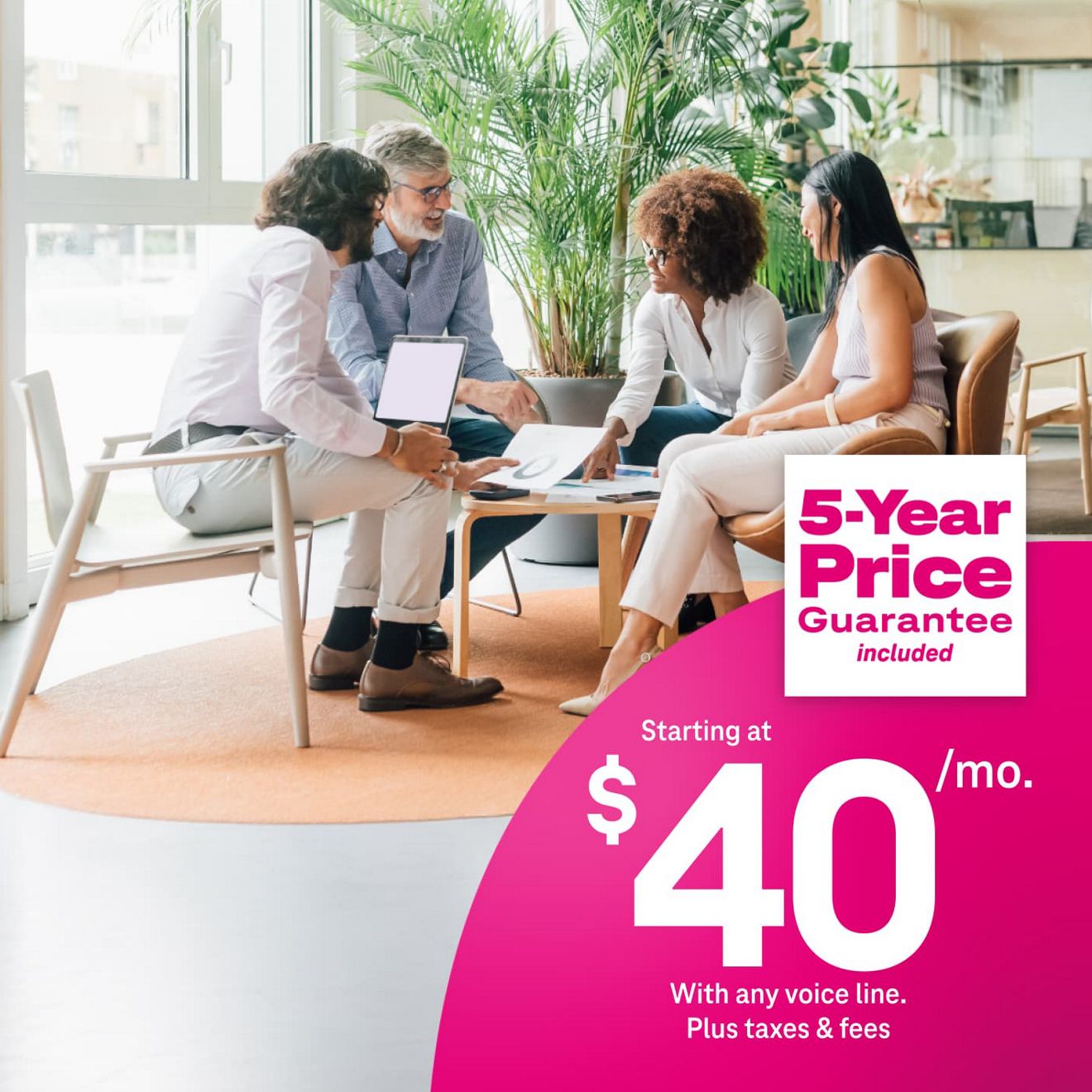 Colleagues working together around a table, using 5G Business Internet for $40 per month with eligible voice line plus taxes and fees, includes 5-year price guarantee.