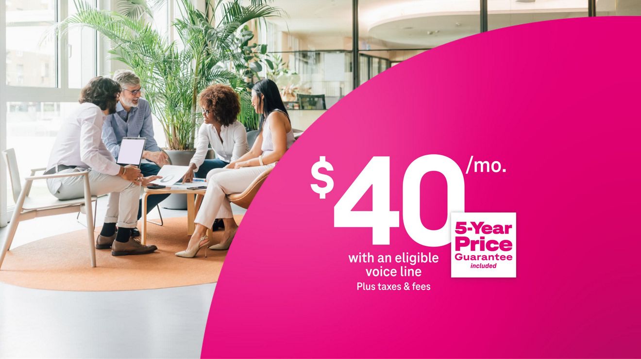 Colleagues working together around a table, using 5G Business Internet for $40 per month with eligible voice line plus taxes and fees, includes 5-year price guarantee.
