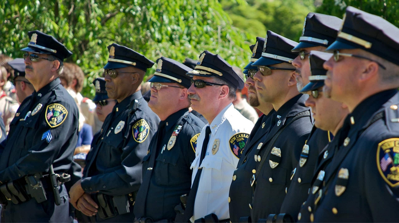 Law enforcement leaders in uniform at an outdoor event, symbolizing next-gen leadership.