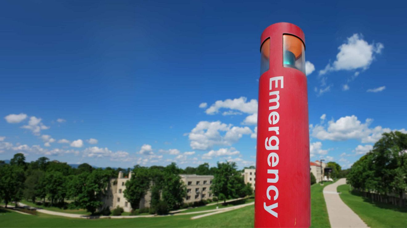 A red emergency call box positioned in a residential apartment complex.