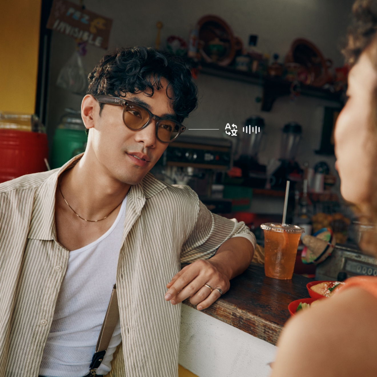 Person wearing Ray-Ban Meta glasses while talking to someone else