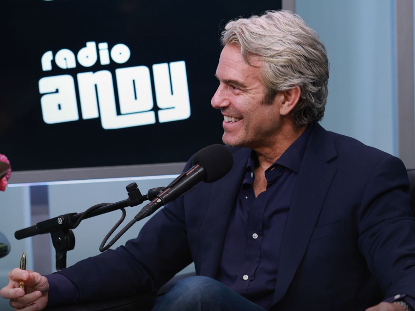 Man sitting and smiling on a podcast