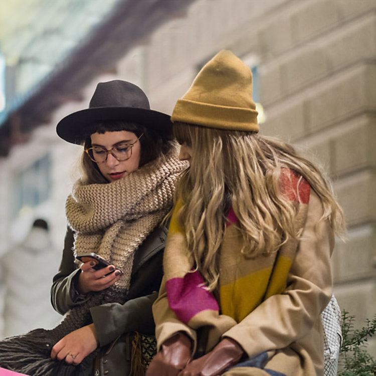 Two women wearing winter clothes