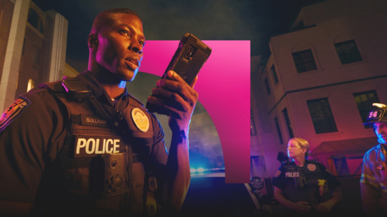 A police officer at the scene of an emergency uses the 5G network to send critical data from a digital device.