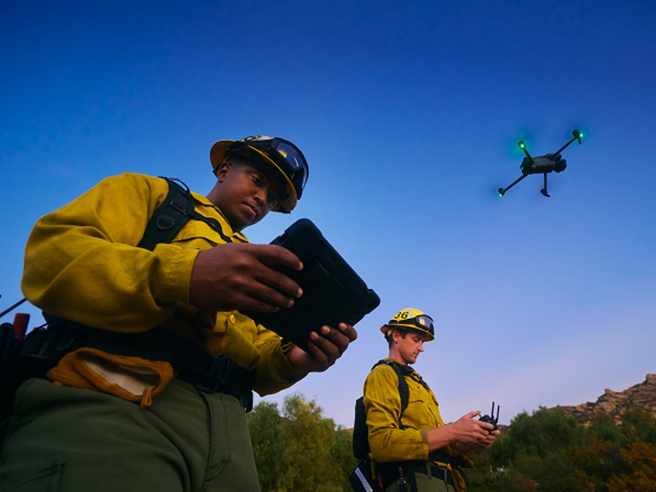 Two drone operators outside