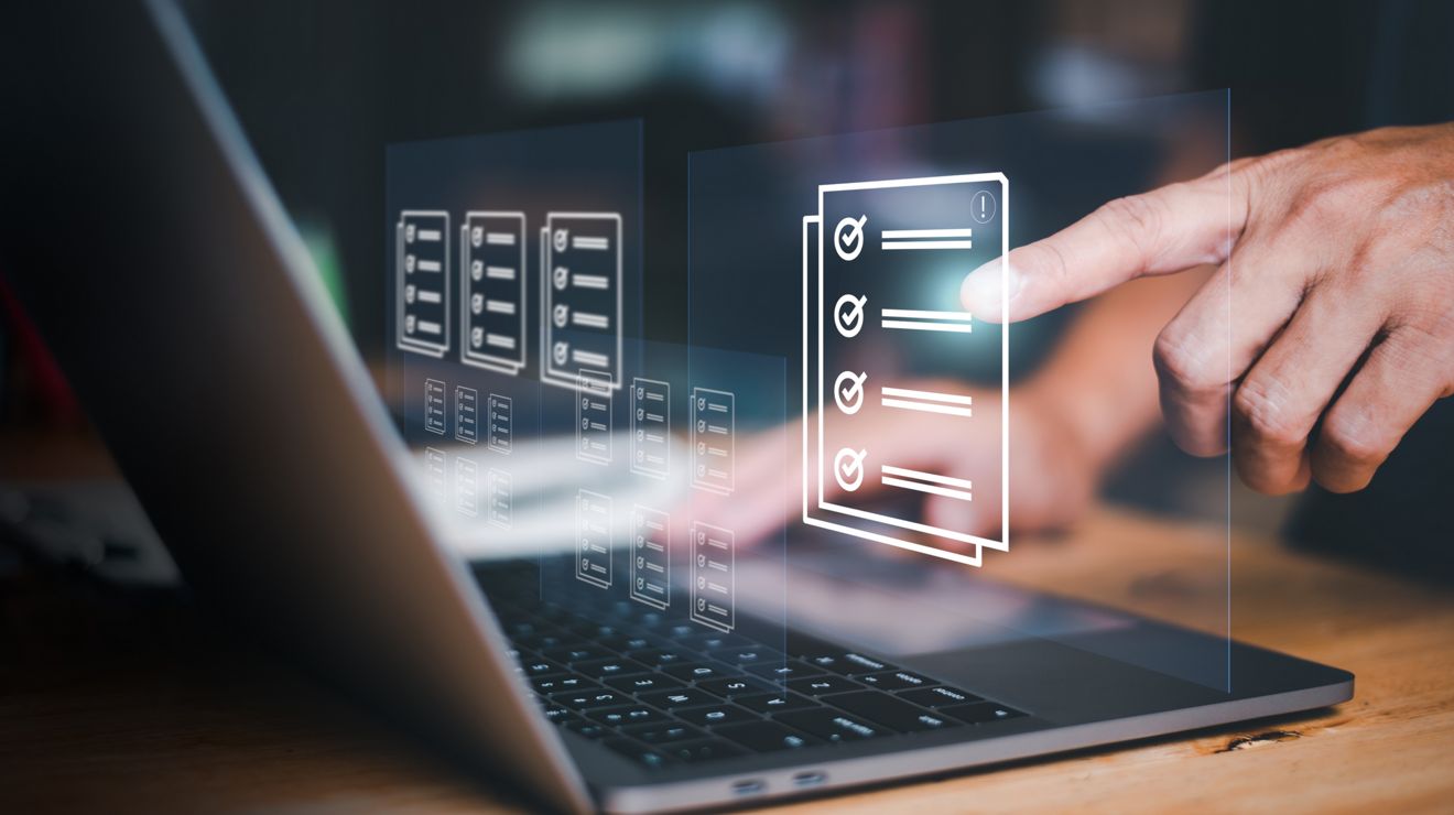 Hand interacting with floating digital checklists and device management panels over a laptop.