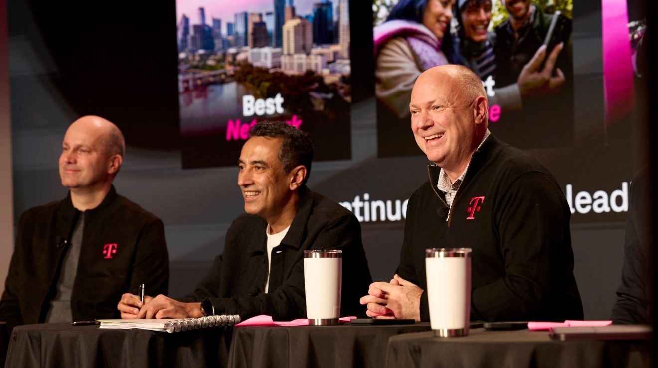 Peter Osvaldik, Srini Gopalan, and Jon Freier are smiling at a table.