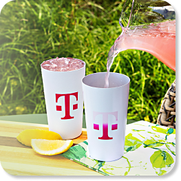 Two T-Mobile tumblers, pink beverage being poured into one of them.