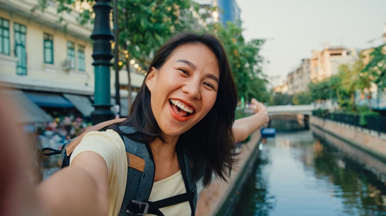 A selfie of a young traveler showing off their surroundings in a European city.