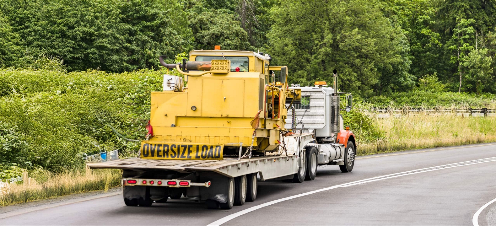 Semi-truck hauling heavy cargo on a highway.