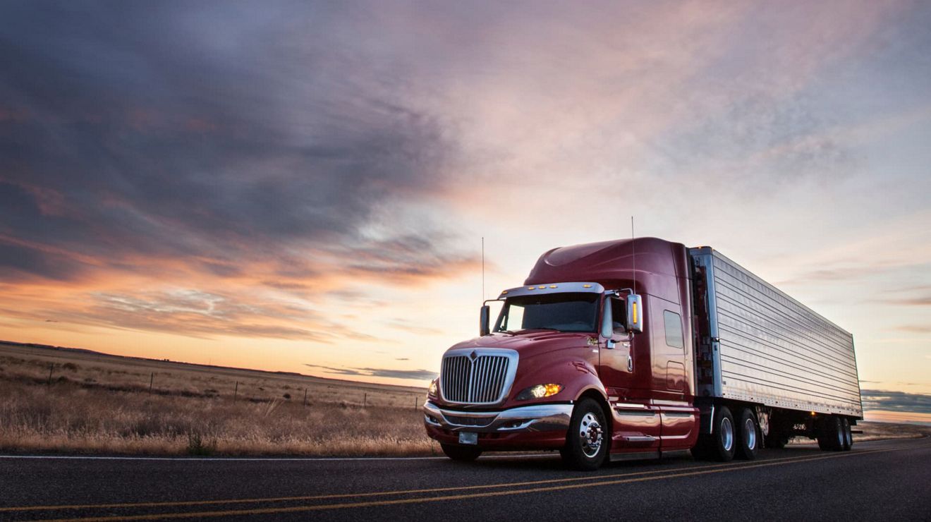 A semi-truck connected to the T-Mobile 5G network travels along a highway.
