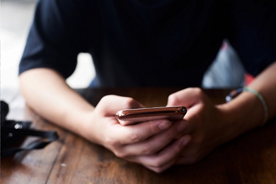 Person typing on phone.