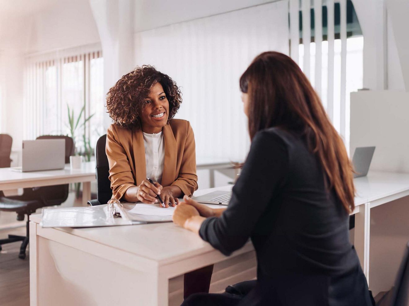 Two business colleagues discuss plans to engage in T-Mobile for Business trial.