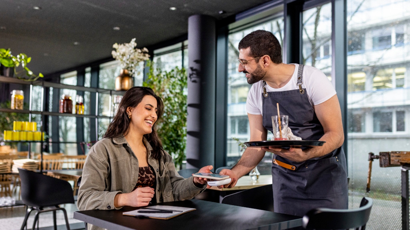 Link: https://www.gettyimages.com/detail/photo/young-and-beautiful-woman-is-paying-with-smartphone-royalty-free-image/1366672869