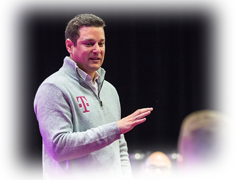 Mike Katz speaking in a grey T-Mobile sweater