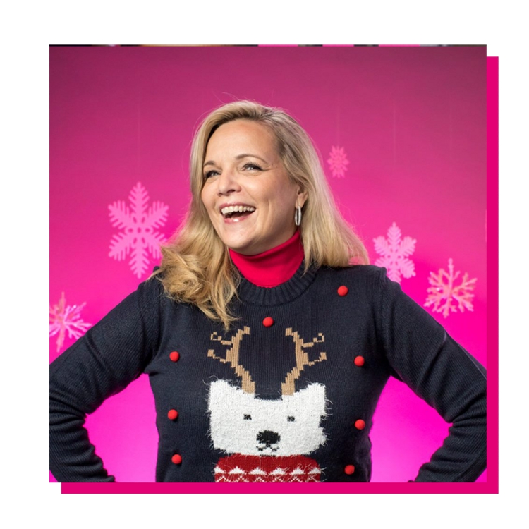 Janice smiling and wearing holiday sweater