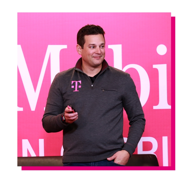 Mike Katz standing in front of a magenta T-Mobile banner