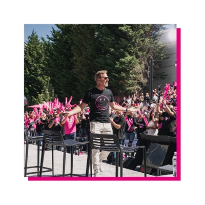 Mike onstage celebrating with employees